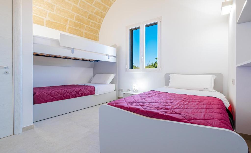 A bed or beds in a room at Villa Falcone - Luxury Pool Sea View