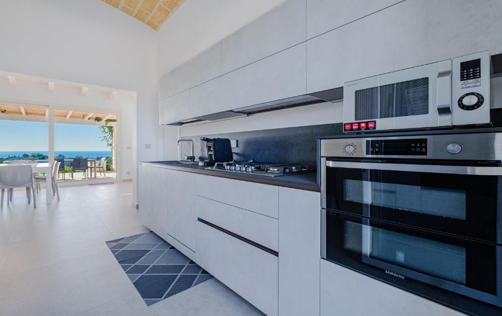 A kitchen or kitchenette at Villa Falcone - Luxury Pool Sea View