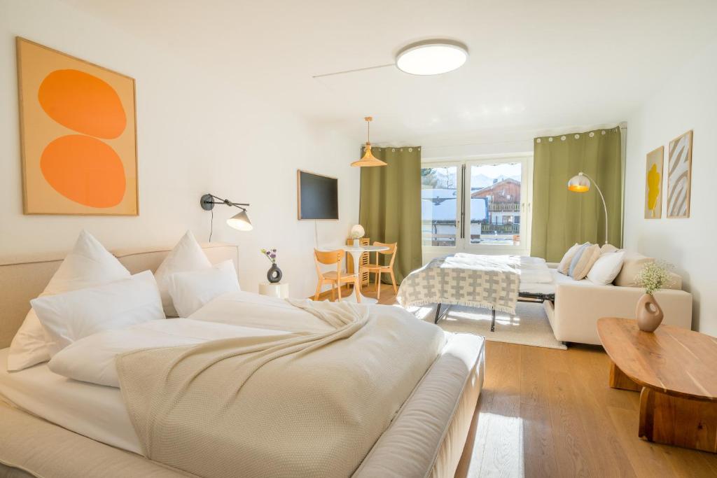 a living room with a white couch and a table at Design-Studio "Fellhorn" im modernen Skandi-Stil in Oberstdorf