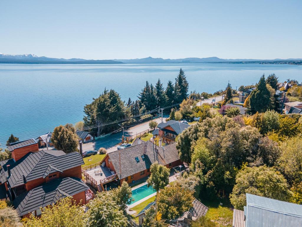 an aerial view of a house on the shore of a lake at Apart Hotel Del Arroyo in San Carlos de Bariloche