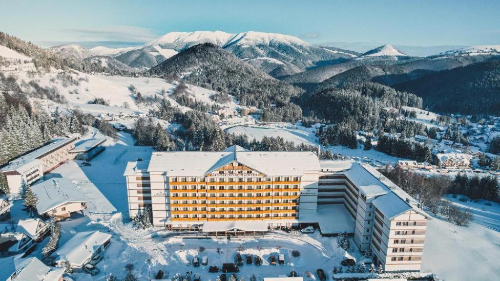 an aerial view of a hotel on a snowy mountain at Apartmán PONIKLEC v hoteli Residence **** in Donovaly