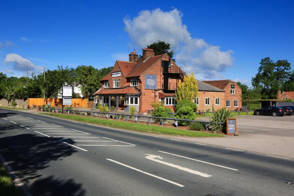 an empty street with a house on the side of the road at The George Carvery & Hotel in Ripon