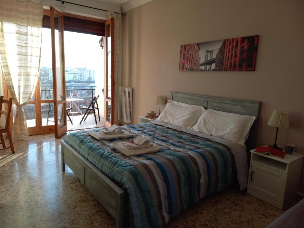a bedroom with a bed with a view of a balcony at Raggio di Sole in Florence