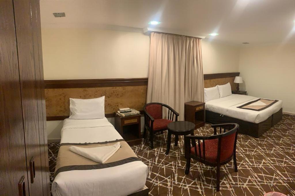 Postel nebo postele na pokoji v ubytování Hotel Abdelmalek Al Azizia