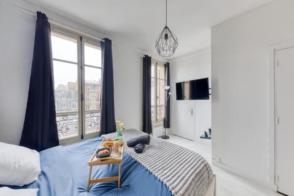 ein Schlafzimmer mit einem Bett und einem großen Fenster in der Unterkunft Guest loc-Le Saphir-3min château in Versailles