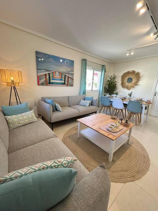 a living room with two couches and a table at Casa Miro in Ciudad Quesada