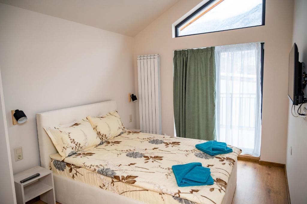 a bedroom with a bed with blue towels on it at Villa Doma in Sapareva Banya