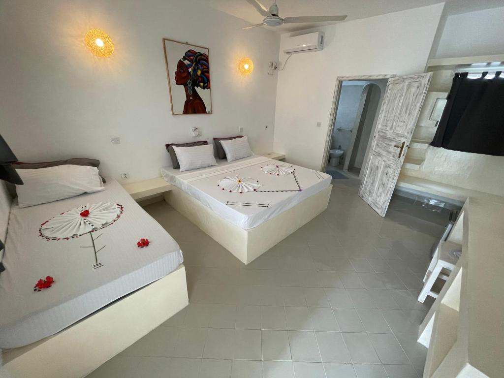 Postel nebo postele na pokoji v ubytování Watamu Ascot Resort