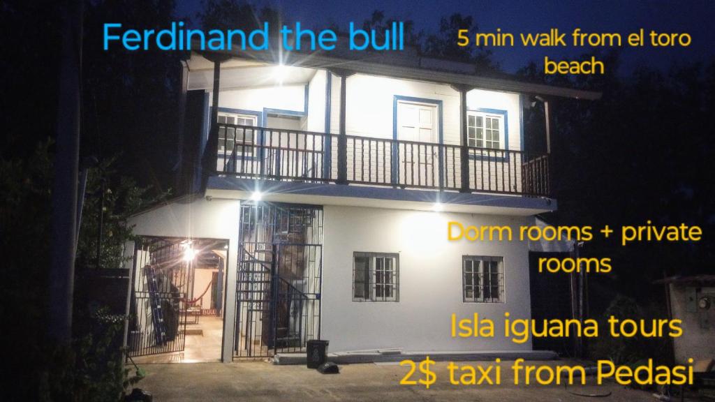 a large white building with a balcony at night at Ferdinand the bull hostel in Pedasí Town