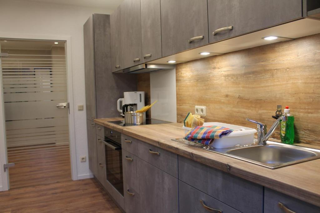 a kitchen with a sink and a counter top at Ferienwohnung Zum Dütetal OG Apartment 1 in Hilter am Teutoburger Wald