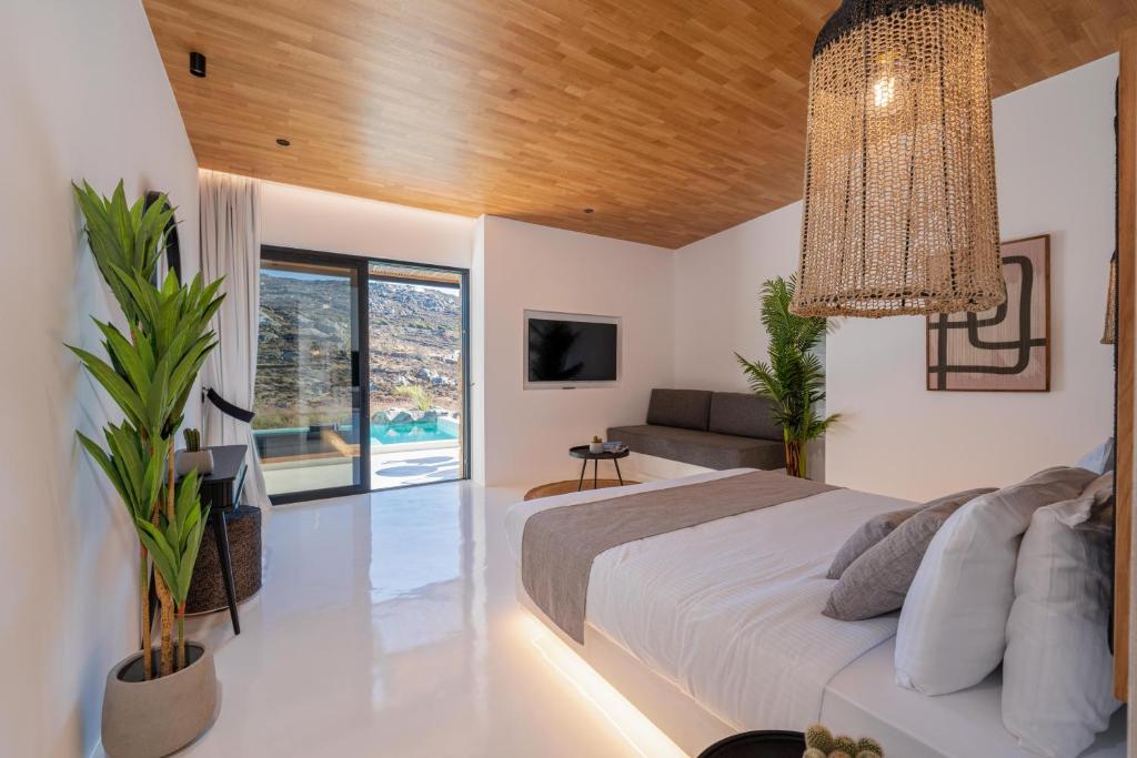 Postel nebo postele na pokoji v ubytování Ftelia Black Villas