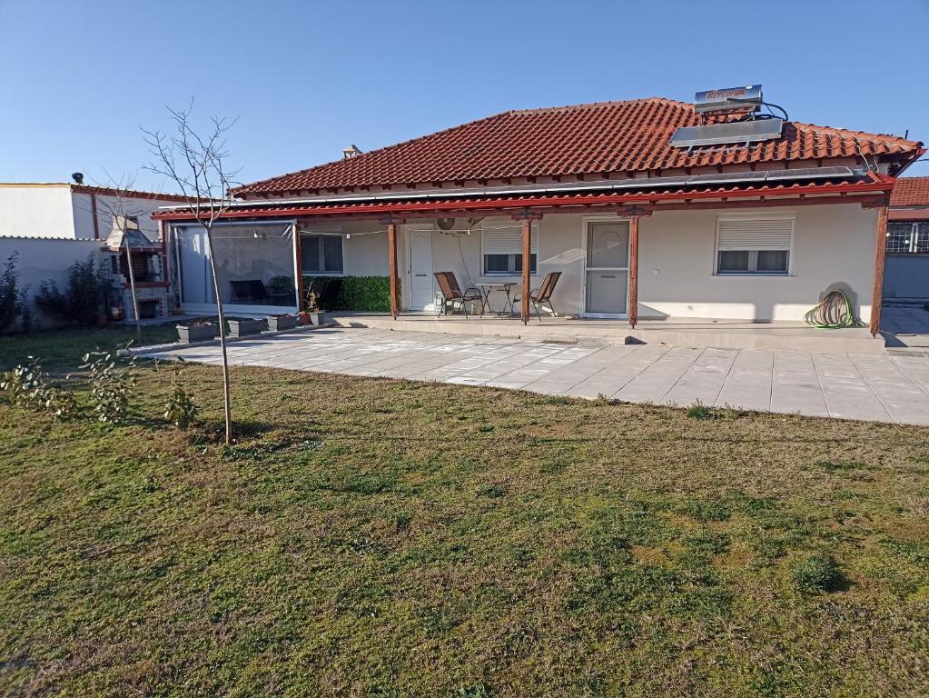a house with a patio and a yard at Kilkis Paradise in Kilkis