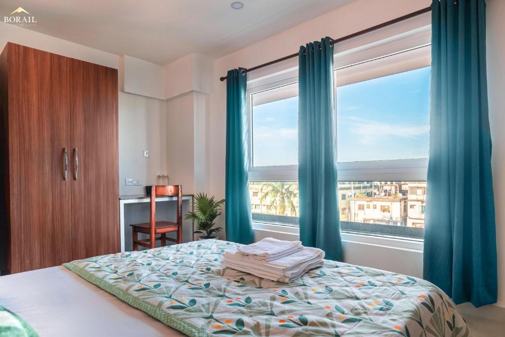 Un pat sau paturi într-o cameră la Borail Homes