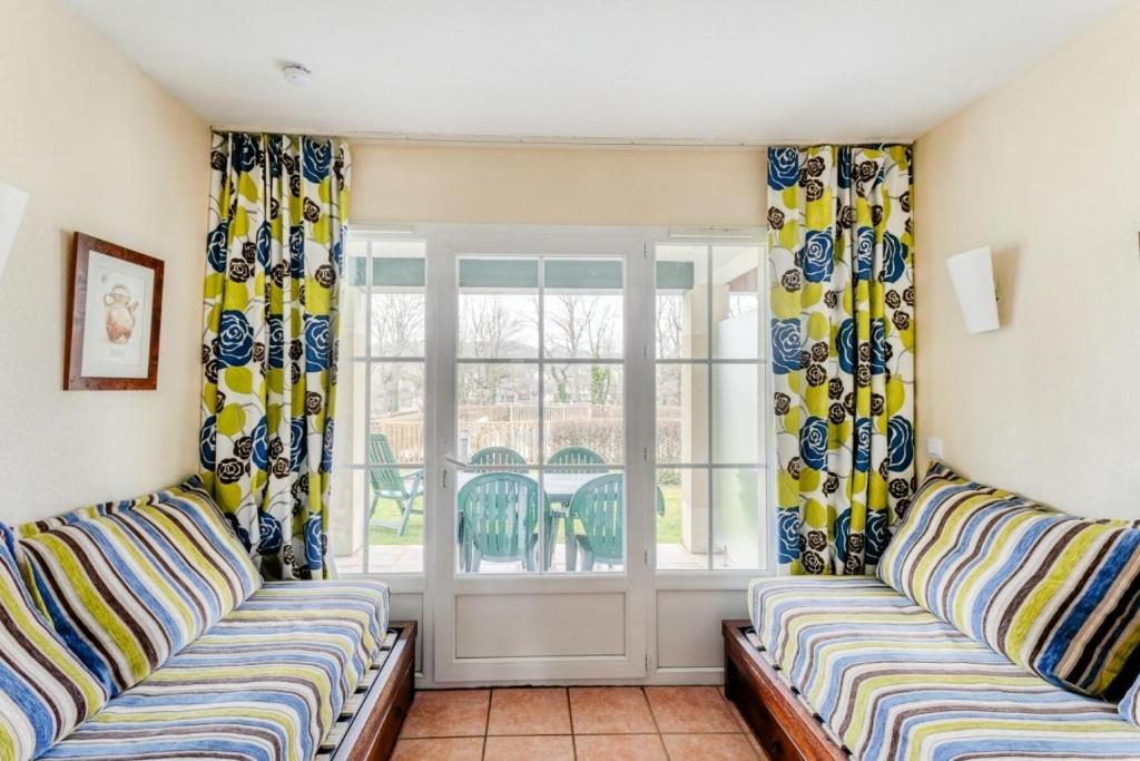 a living room with two couches and a window at Résidence Les Belles Rives - maeva Home - Appartement 2 Pièces 5 Personnes - Confort MAE-2284 in Argentat