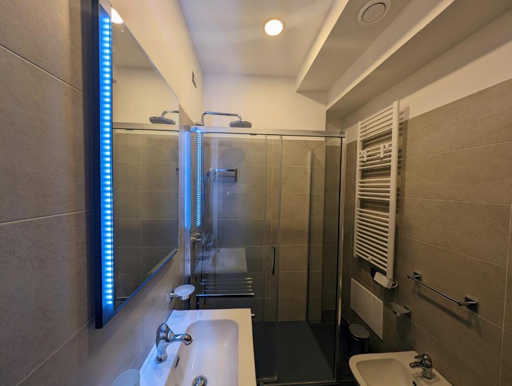 a bathroom with a sink and a shower and a toilet at Benedict Rooms in Bologna
