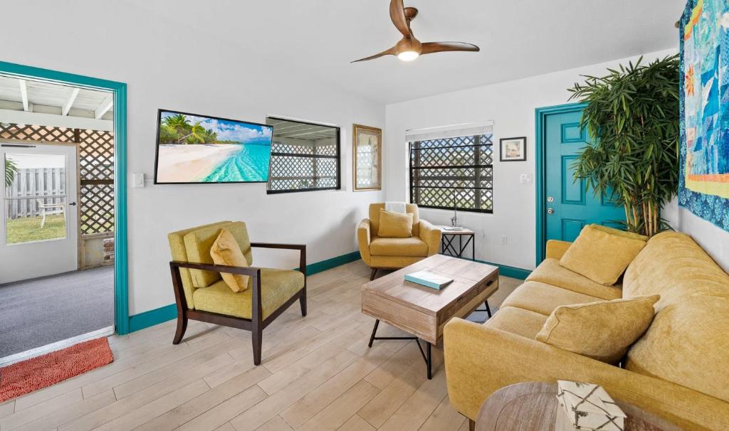 a living room with a couch and chairs at Uptown Cottage - Walk to the Beach and Restaurants in Cocoa Beach