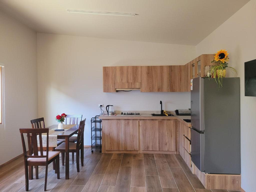 a kitchen with a refrigerator and a table and chairs at Arriendo diario Futrono in Futrono