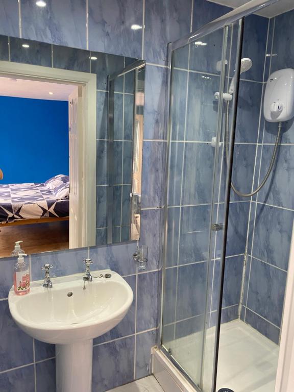 a bathroom with a sink and a shower at Heather's Lodge in Cheshunt