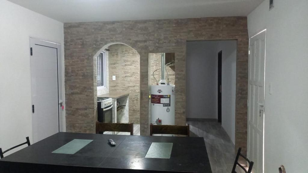 a dining room with a table and a refrigerator at Casa Familiar in Mar del Plata