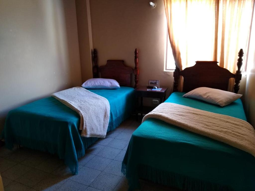 Postel nebo postele na pokoji v ubytování Hotel Tahami