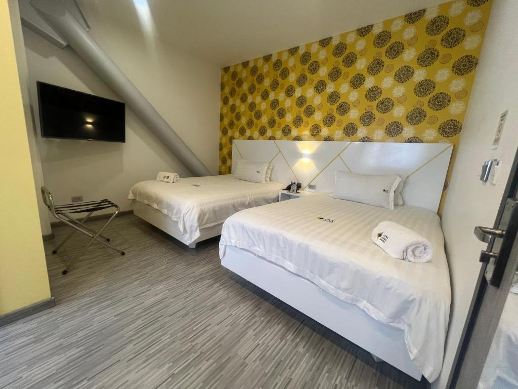 Postel nebo postele na pokoji v ubytování Luma Plaza Hotel