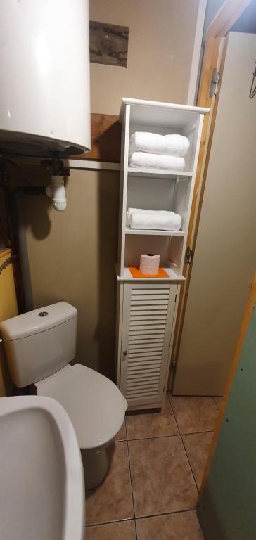 a bathroom with a white toilet and some towels at RELAX in Montreuil