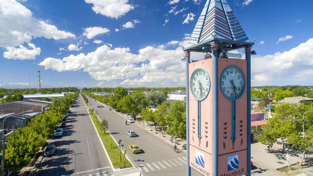 a clock tower in a city with a street at Aires de Montaña in Malargüe