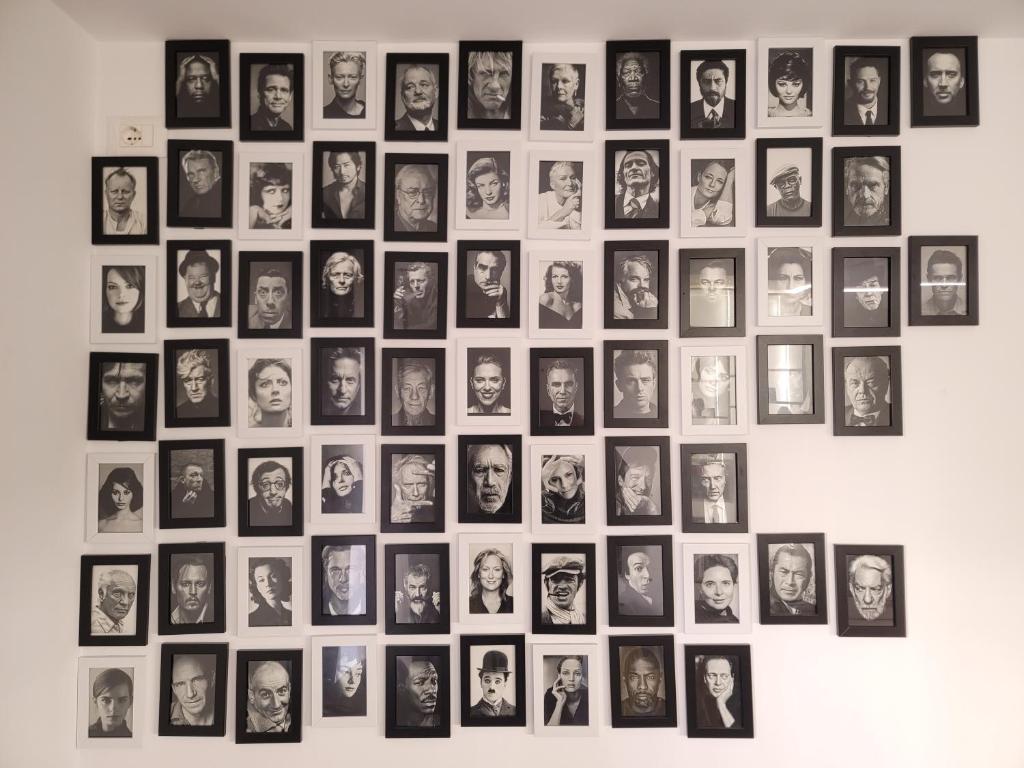 a bunch of pictures on a wall at The Actors Studio in Tirana