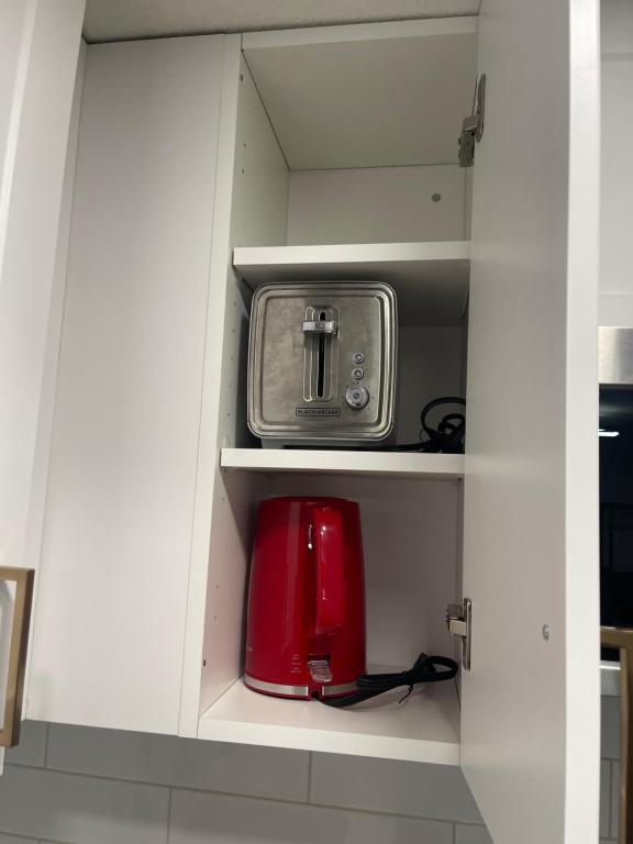 a white cupboard with a toaster and a toaster at Stylish 2 Bedroom suite in SW Edmonton close to Windermere and Edmonton International Airport in Edmonton
