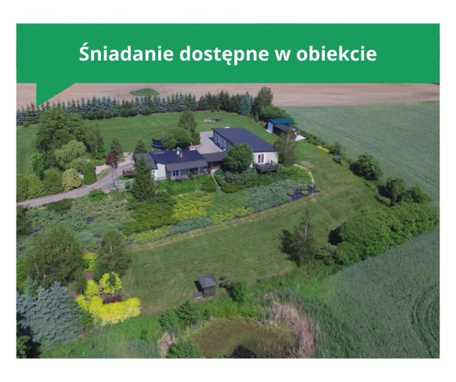 an aerial view of a house in a field at Port Rybaki & Vine Agritourism in Brodnica