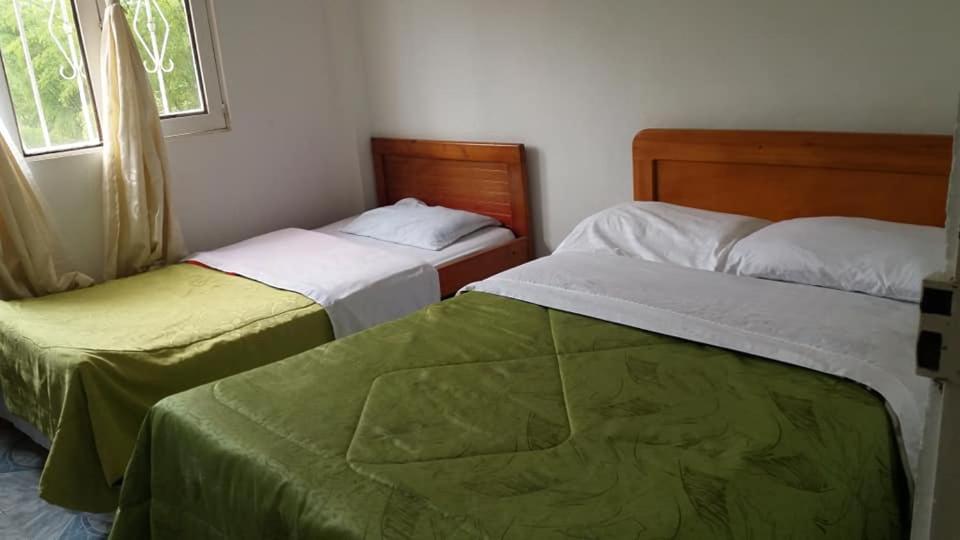 two beds sitting next to each other in a bedroom at HOTEL REAL VILLA ISABELLA in San Agustín