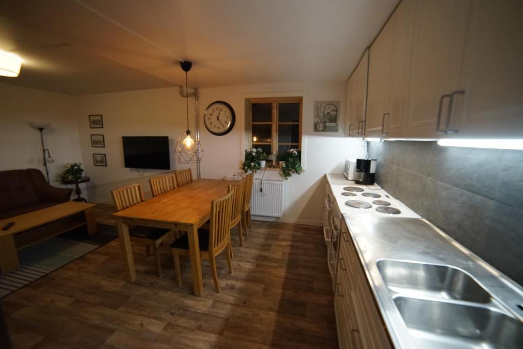 a kitchen with a table and a dining room at House close to the Sea in Sundsvall