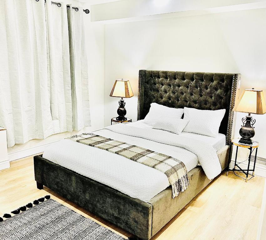 a bedroom with a large bed and two lamps at LaVida Exclusive Guest House, Free Parking (Rm#2) in London