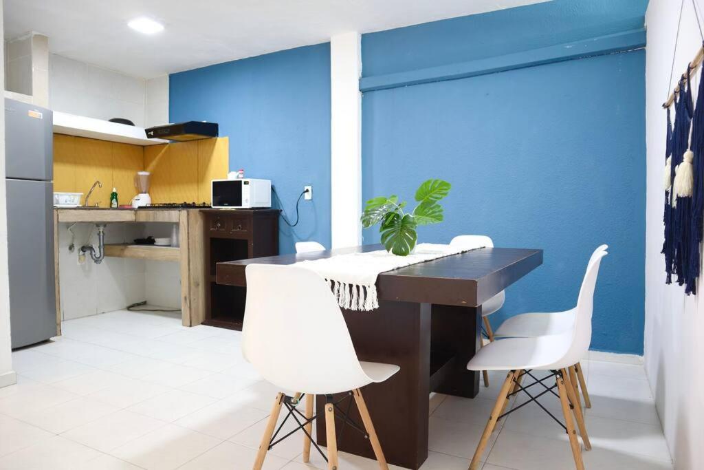 a kitchen with a table and white chairs at Beach apt, 2 bedrooms, 2 min Plaza la Isla - Mar312 - in Cancún