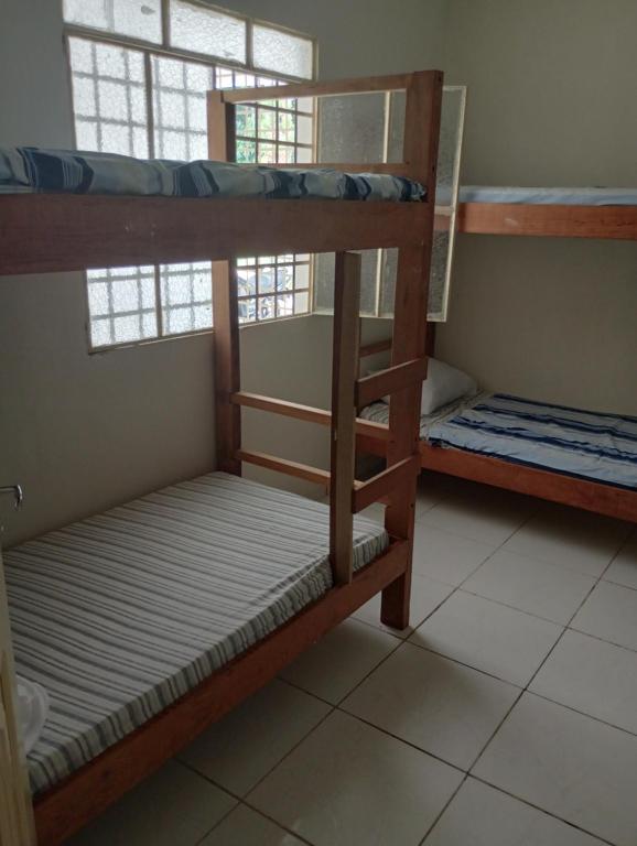 two bunk beds in a room with a window at AM-RR Hostel in Manaus