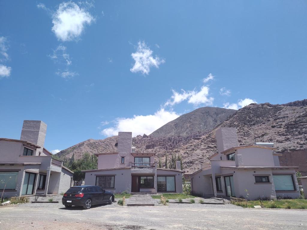 a car parked in a parking lot in front of houses at Möller Masi in Purmamarca