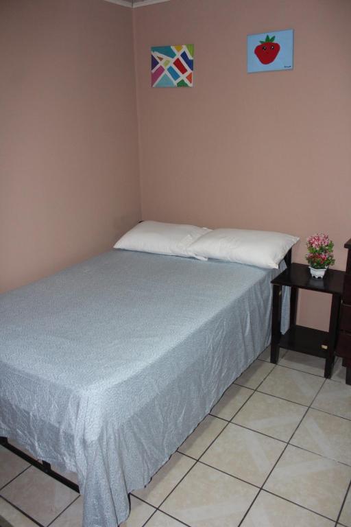 a bedroom with a bed and a side table at Hotel El Dorado in San José