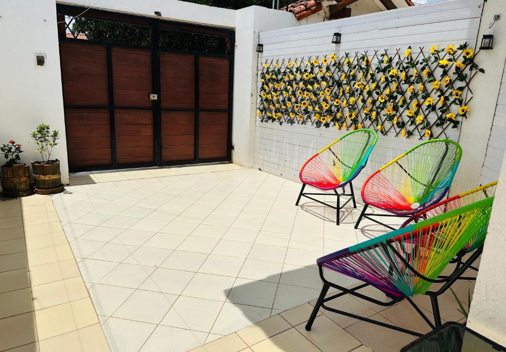 two colorful chairs sitting on a patio with a garage at Departamento 2 habitaciones Trinidad Beni in Trinidad