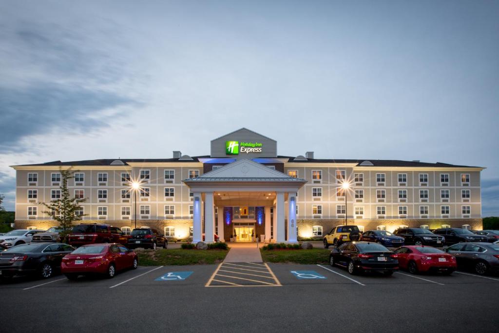 a large hotel with cars parked in a parking lot at Holiday Inn Express Stellarton-New Glasgow, an IHG Hotel in Stellarton