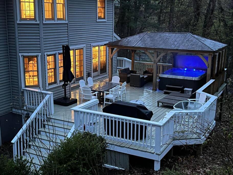 a deck with a gazebo with a couch at LakePath Beach House - XL hot tub, walk to beach in Coloma