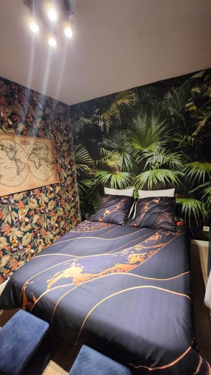 ein Schlafzimmer mit einem großen Bett mit Pflanzen an der Wand in der Unterkunft Villa 20 min de Paris avec spa, piscine chauffée et club in Gagny
