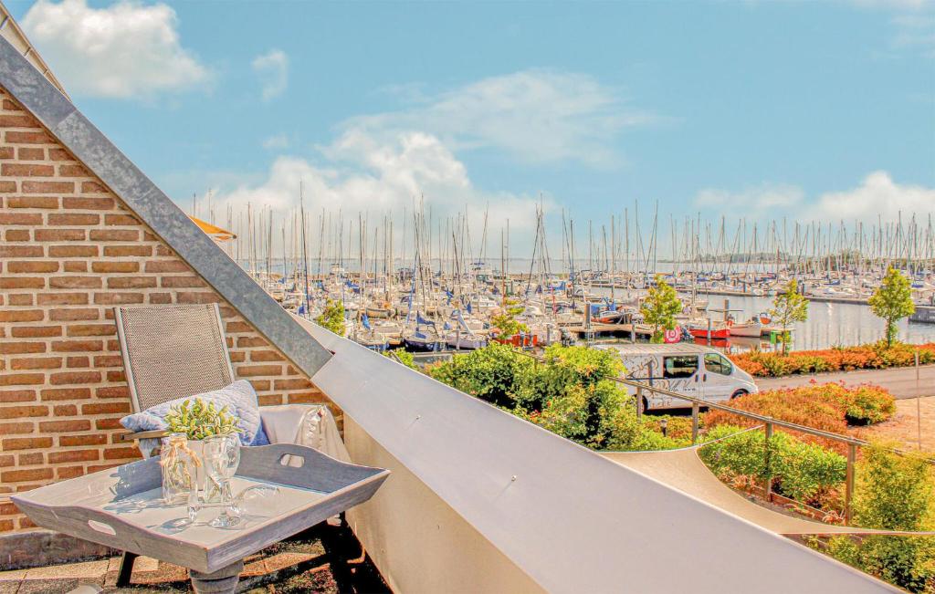 a balcony with a table and a view of a harbor at Beautiful Home In Bruinisse With Kitchen in Bruinisse