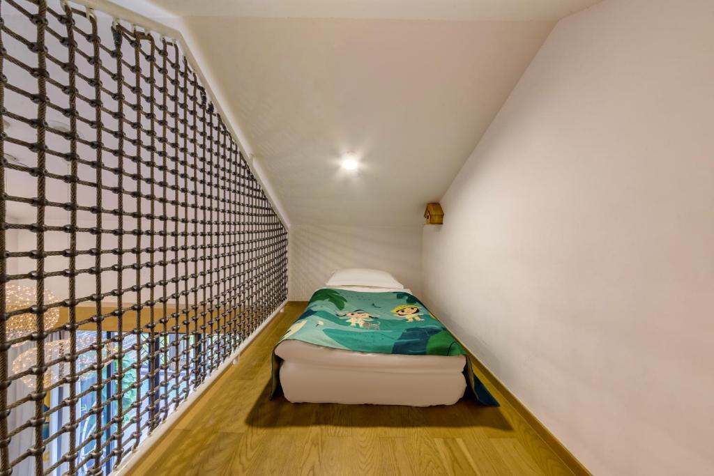Postel nebo postele na pokoji v ubytování Little Hakka Hotel