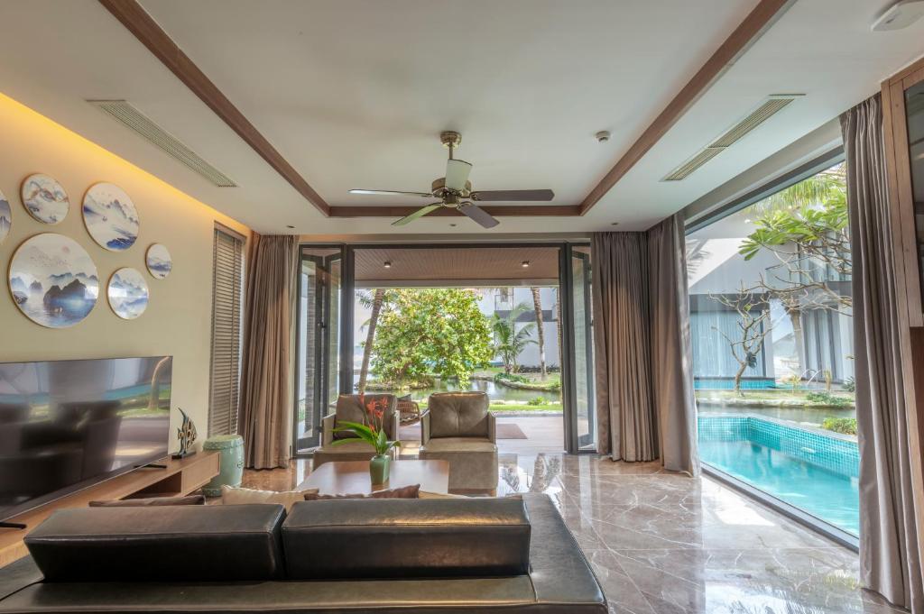 A villa-style living room opening directly onto a pool terrace.