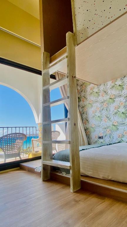 a bedroom with a bunk bed with a view of the ocean at Mini Summer in Nanwan