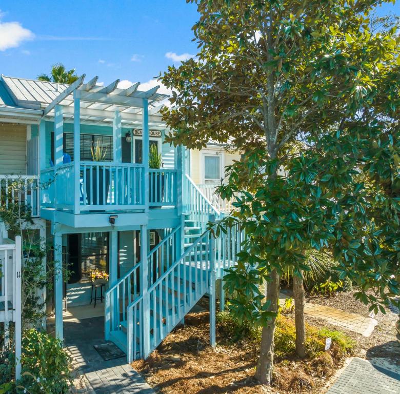 a blue house with a staircase and a tree at Solitude on 30A - Seacrest Beach Townhouse with Beach Access - FREE BIKES in Rosemary Beach