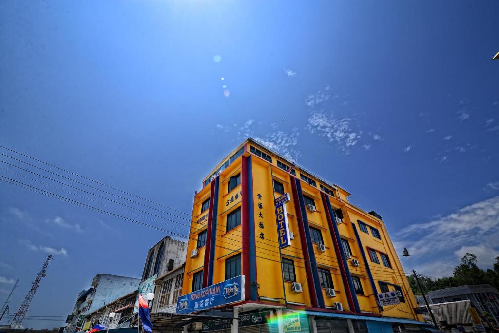 a yellow building on the side of a street at Mersing Hotel in Mersing