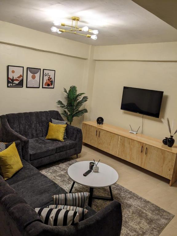 TV a/nebo společenská místnost v ubytování Rawin Homes
