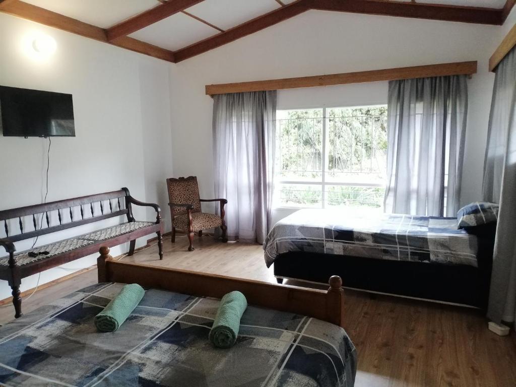 a bedroom with two beds and a large window at Nandi's Place in Harrismith