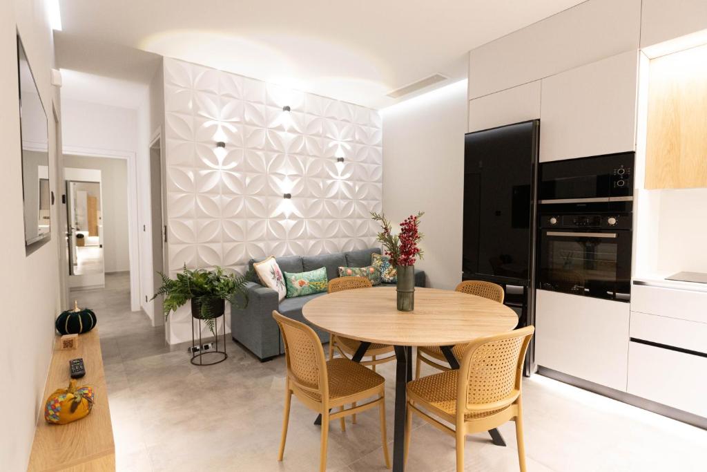 a kitchen and living room with a table and chairs at BillMar Luxury Apartment in the center of Gythio in Gythio